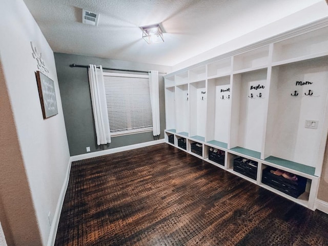 mudroom featuring dark hardwood / wood-style floors and a textured ceiling