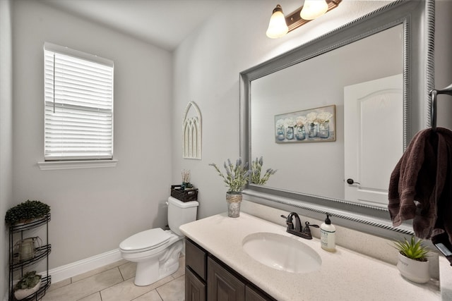 bathroom featuring vanity, toilet, and tile patterned flooring