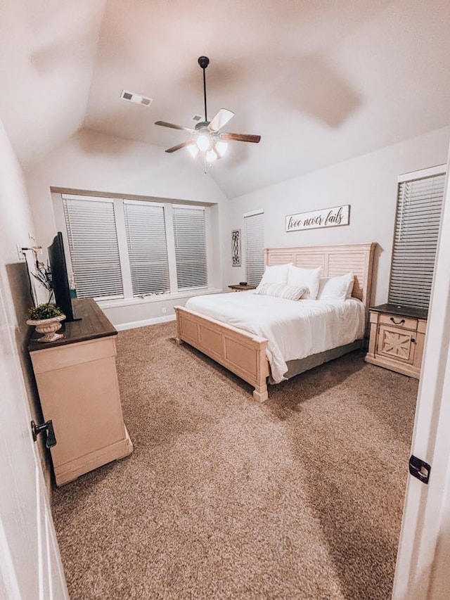 bedroom with vaulted ceiling, ceiling fan, and carpet flooring