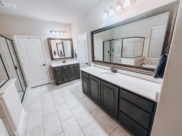 bathroom with vanity, tile patterned flooring, and walk in shower