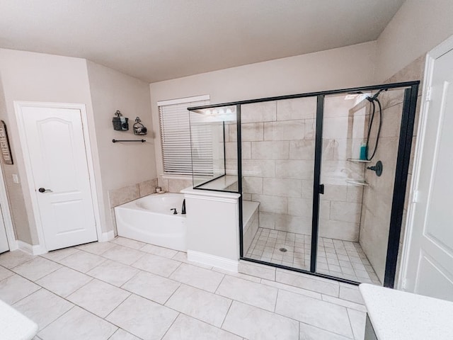 bathroom with tile patterned flooring and separate shower and tub