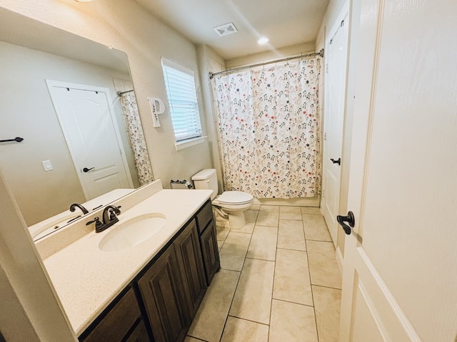 bathroom featuring vanity, tile patterned floors, and toilet