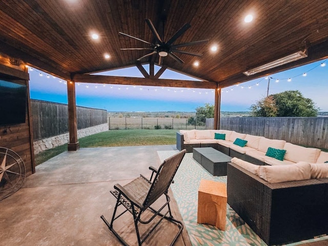 patio terrace at dusk featuring ceiling fan and outdoor lounge area