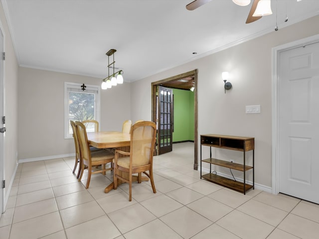 tiled dining room featuring crown molding and ceiling fan