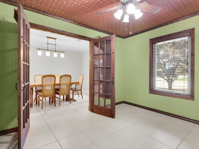 dining space featuring crown molding, french doors, and ceiling fan