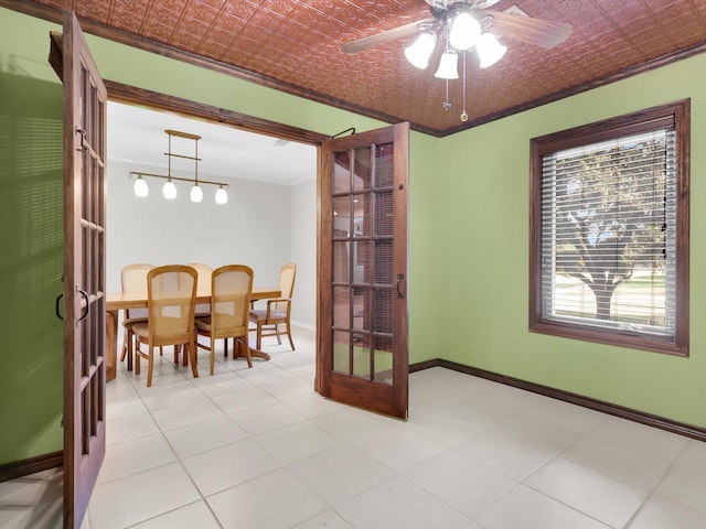 dining space with an ornate ceiling, ceiling fan, and baseboards
