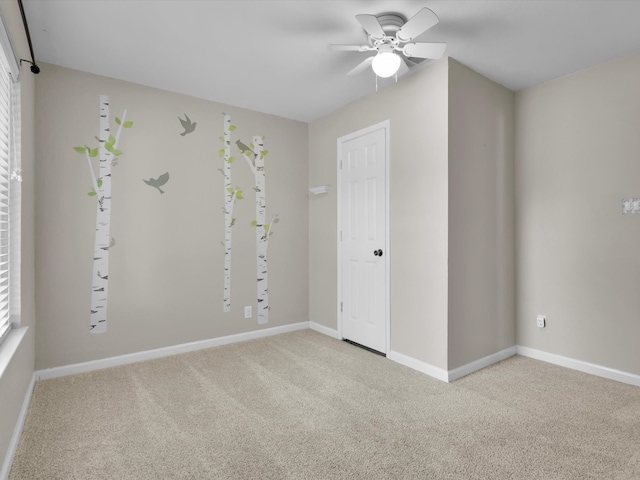 spare room featuring ceiling fan and carpet flooring