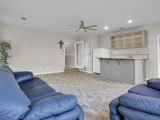 living room with sink and ceiling fan