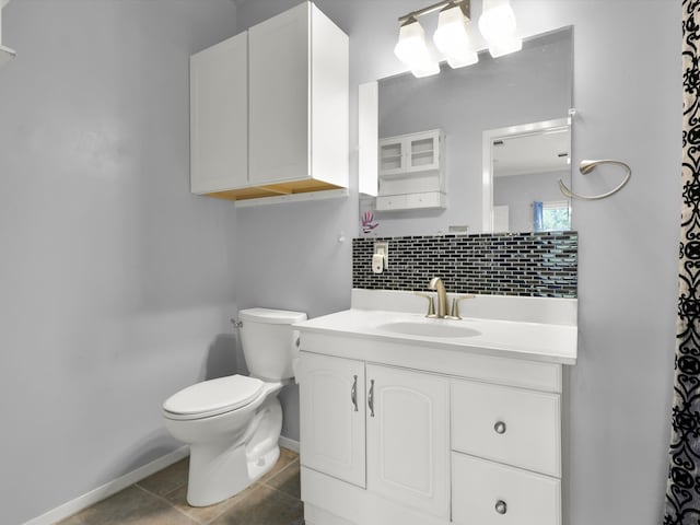 bathroom with vanity, toilet, decorative backsplash, and tile patterned flooring