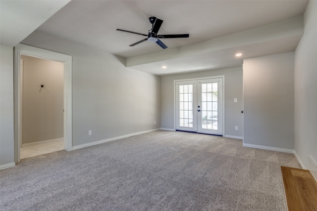 carpeted spare room with french doors and ceiling fan