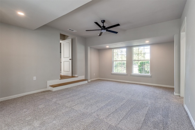 unfurnished room with ceiling fan and carpet floors