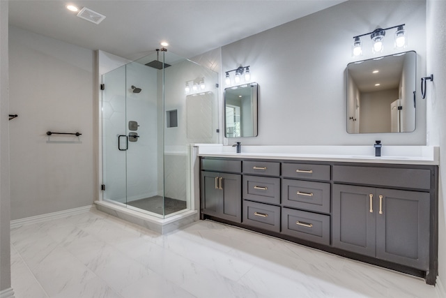 bathroom with vanity and a shower with shower door