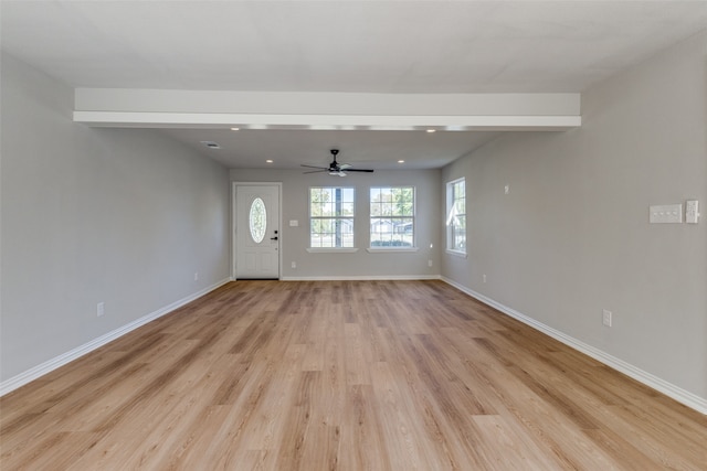 unfurnished living room featuring light hardwood / wood-style floors and ceiling fan