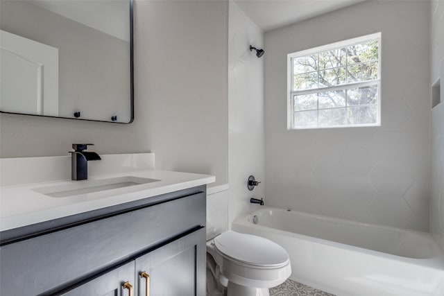 full bathroom featuring vanity, tiled shower / bath, and toilet