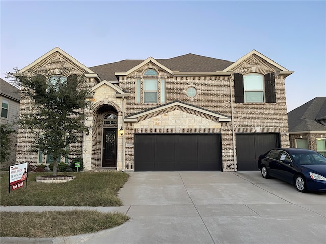 view of front of home with a front yard and a garage