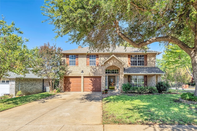 view of front of property with a front yard and a garage