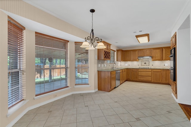 kitchen featuring appliances with stainless steel finishes, decorative light fixtures, sink, ornamental molding, and light stone counters