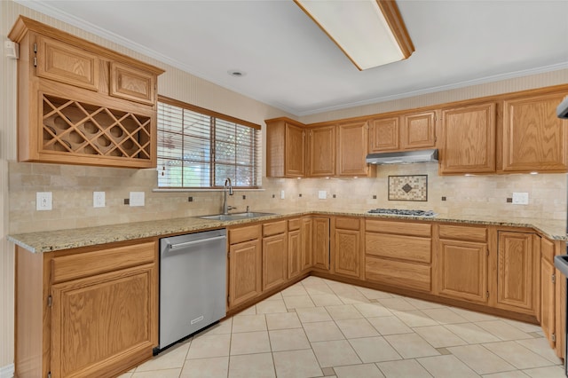 kitchen with under cabinet range hood, stainless steel appliances, light stone counters, and a sink