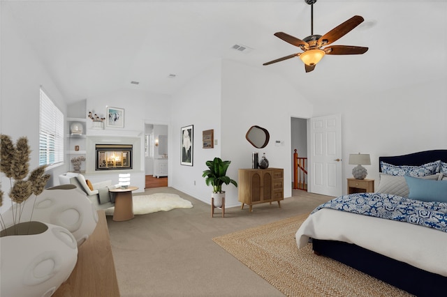 carpeted bedroom with baseboards, visible vents, a multi sided fireplace, and high vaulted ceiling