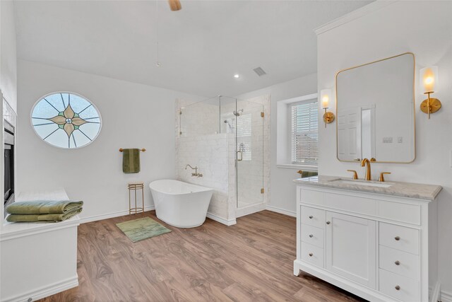 bathroom featuring vanity, hardwood / wood-style flooring, and separate shower and tub