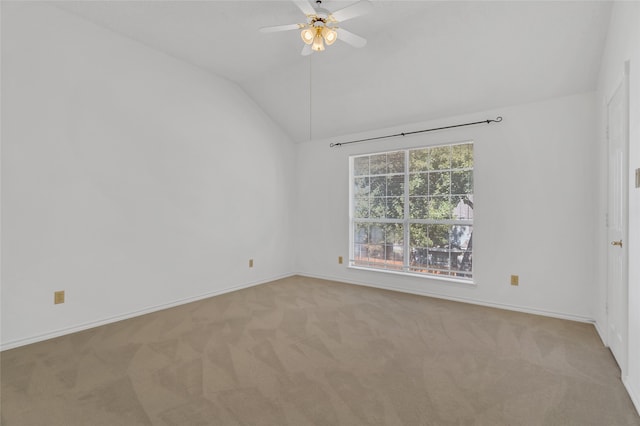 carpeted spare room with ceiling fan and lofted ceiling