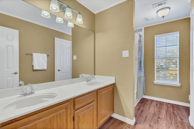 bathroom featuring crown molding, hardwood / wood-style floors, and vanity