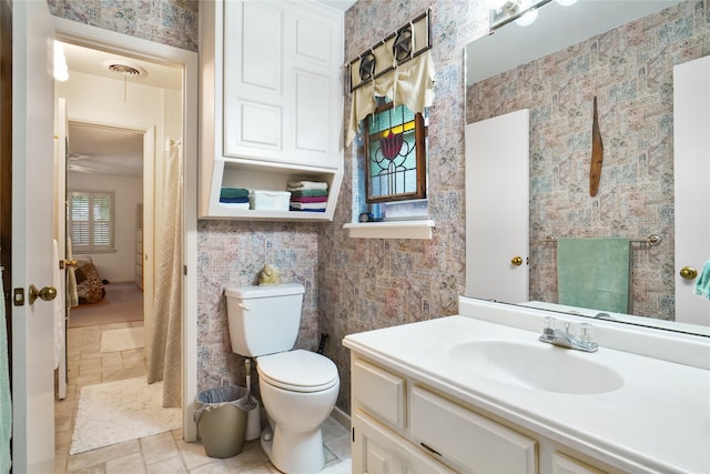 bathroom featuring toilet and vanity