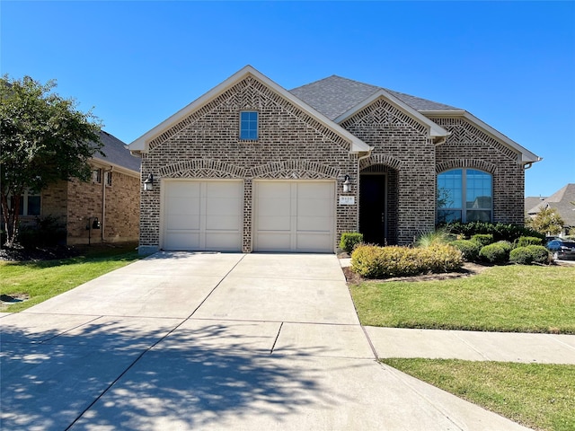 view of front of property with a front yard and a garage