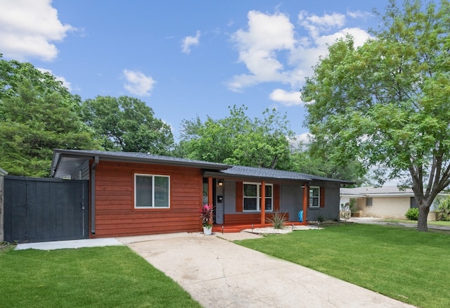 ranch-style house with a front lawn and covered porch