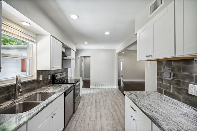 kitchen with sink, white cabinetry, light wood-type flooring, and tasteful backsplash