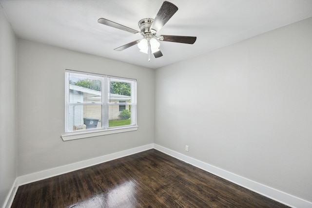 spare room with dark hardwood / wood-style floors and ceiling fan