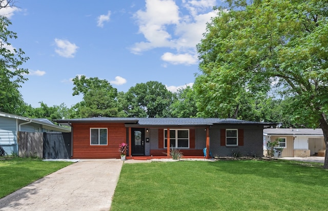 single story home with a porch and a front lawn