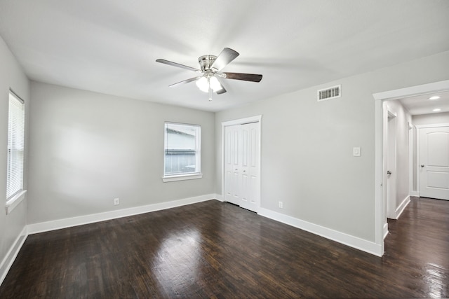 spare room with ceiling fan and dark hardwood / wood-style flooring