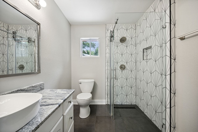 bathroom with a shower with door, vanity, and toilet