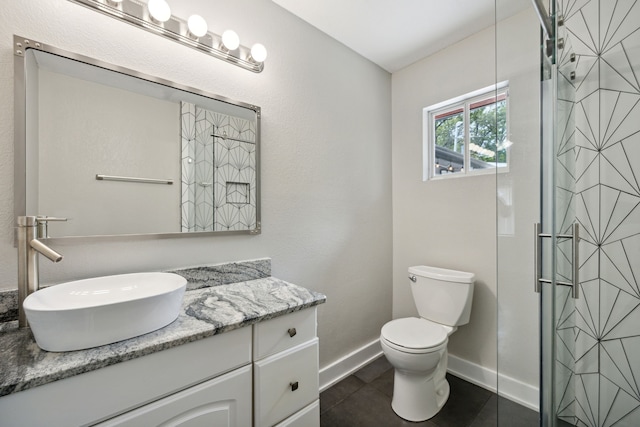 bathroom featuring a shower with door, vanity, toilet, and tile patterned flooring