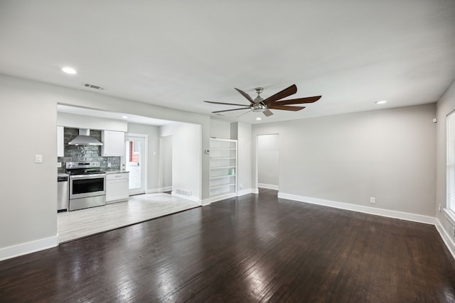 unfurnished living room featuring wood-type flooring, built in features, and ceiling fan