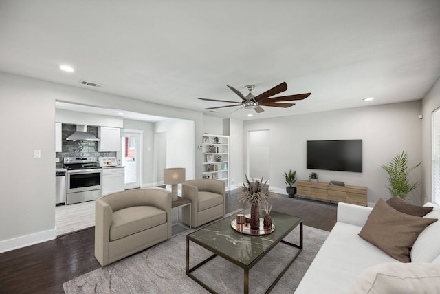 living room with ceiling fan, a healthy amount of sunlight, and hardwood / wood-style floors