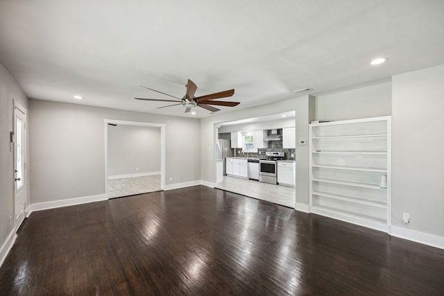 unfurnished living room featuring hardwood / wood-style flooring and ceiling fan