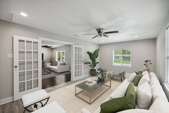 living room featuring hardwood / wood-style floors, french doors, and ceiling fan