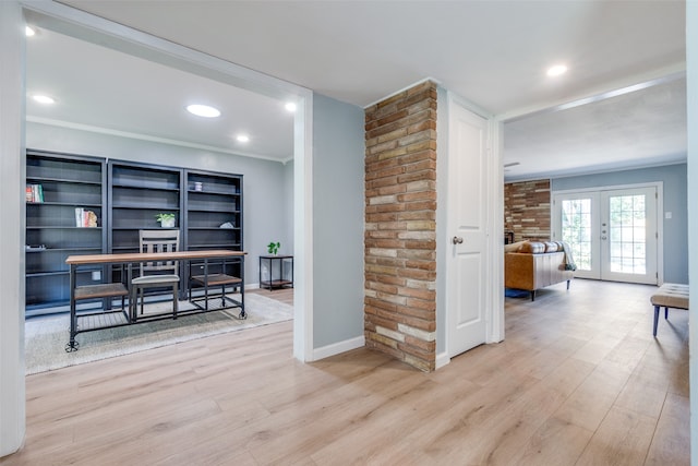 interior space featuring light hardwood / wood-style flooring, french doors, and crown molding