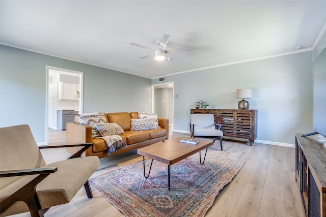 living room with crown molding, light wood-type flooring, and ceiling fan