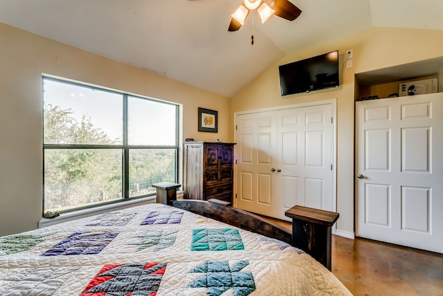 bedroom with a closet, ceiling fan, vaulted ceiling, and multiple windows