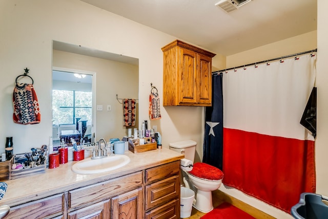 bathroom featuring toilet, a shower with curtain, and vanity