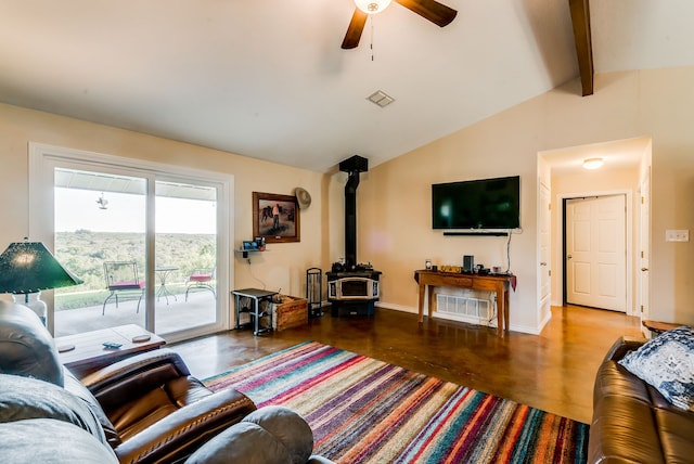 living room featuring ceiling fan, lofted ceiling with beams, and a wood stove