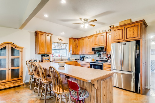 565 Turkey Ridge Rd, Stephenville, TX 76401 - kitchen featuring stainless steel appliances, light countertops, a ceiling fan, a breakfast bar area, and a sink