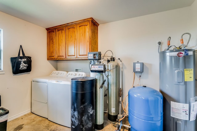 565 Turkey Ridge Rd, Stephenville, TX 76401 - clothes washing area featuring electric water heater, cabinet space, washing machine and dryer, and baseboards