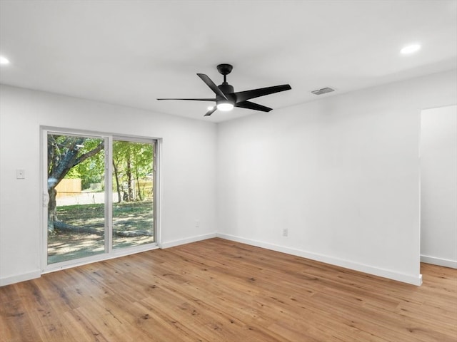 spare room featuring ceiling fan and light hardwood / wood-style flooring