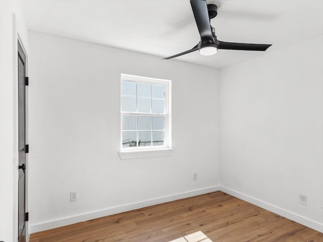 empty room featuring ceiling fan and hardwood / wood-style floors