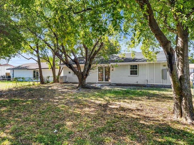 rear view of house with a lawn