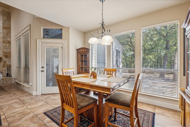 dining space with a chandelier and light tile patterned floors